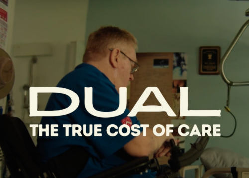 A picture of a mad with white hair wearing glasses looking at medical equipment. White letters over the image read DUAL: The True Cost of Care